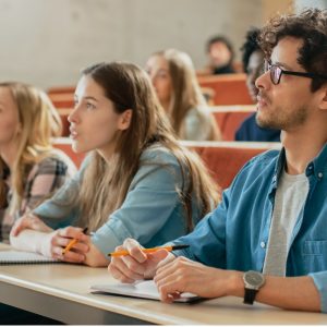 Individuals sitting and listening in a lecture hall