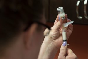 Woman filling up syringe