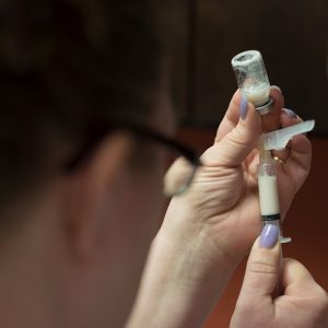 Woman filling up syringe