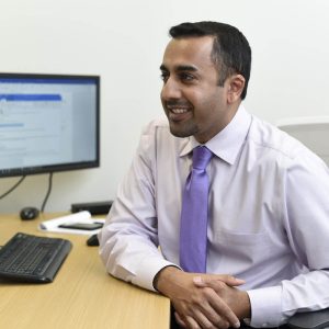 Man smiling sitting at desk