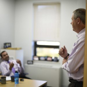 Two men talking in office