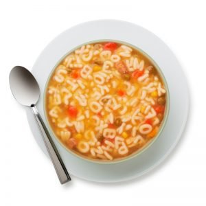 Alphabet soup in white bowl and spoon